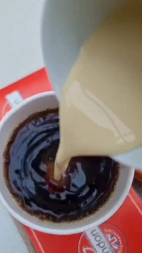 Milk being poured into tea