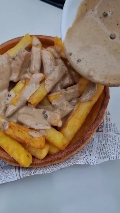 Homemade sauce poured over fries