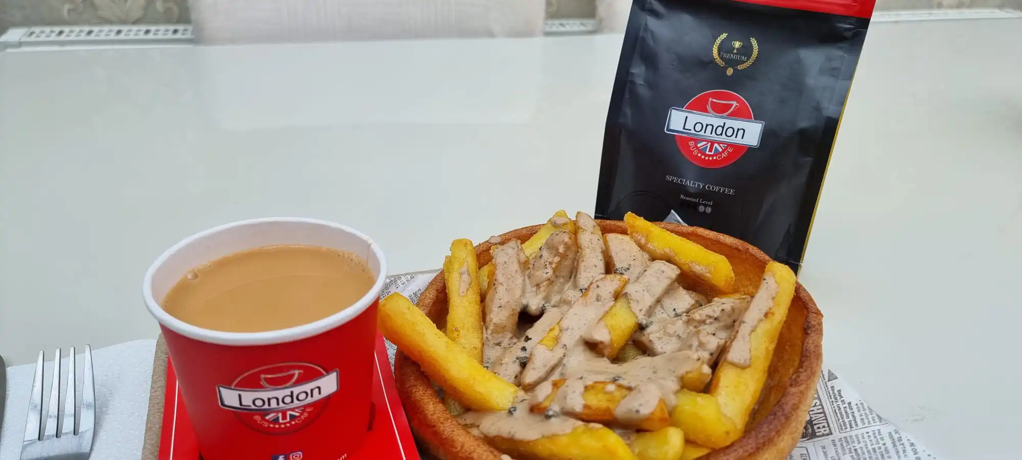 Fries with homemade sauce and a cup of tea from London Bus Cafe